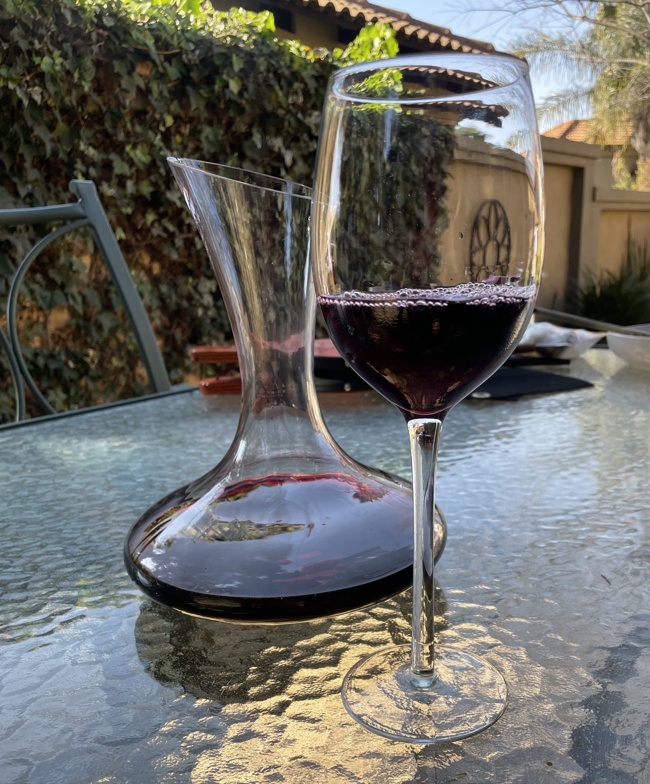 glass of wine and decanter on table